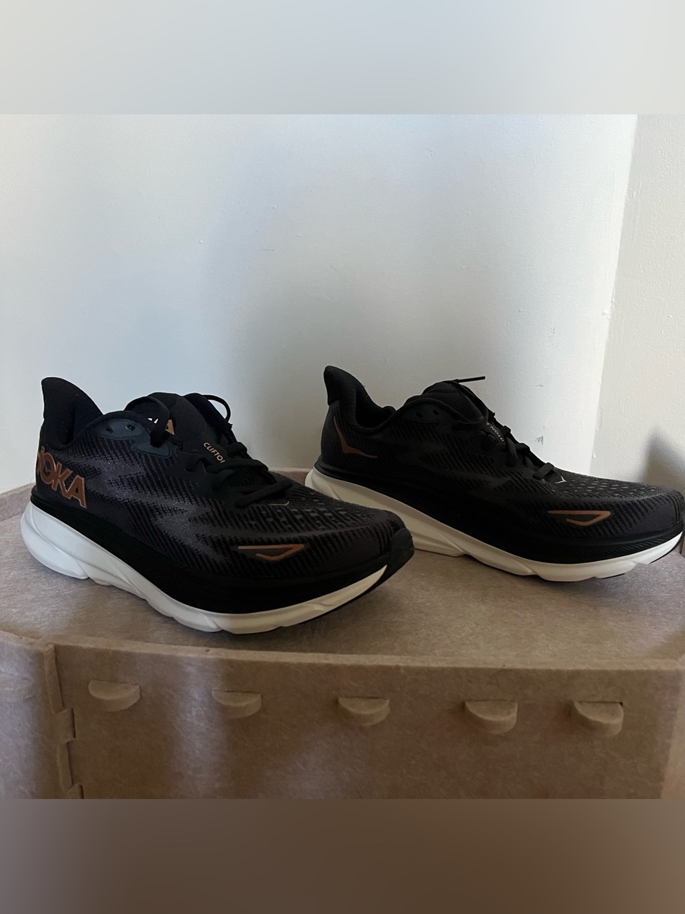 Hoka woman’s Black Running Shoes with Copper Accents